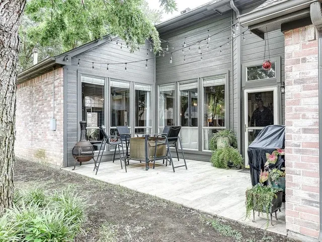 a view of a building with sitting area and garden
