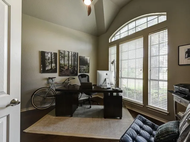 a living room with furniture a large window and flat screen tv