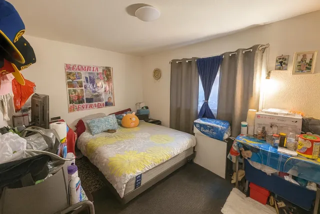 a bedroom with a bed and a flat tv screen