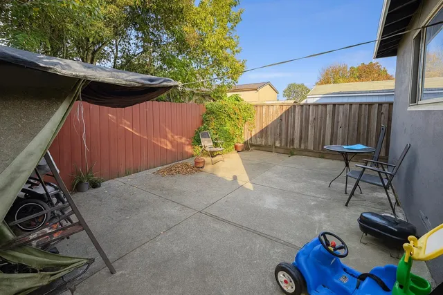a backyard of a house with table and chairs