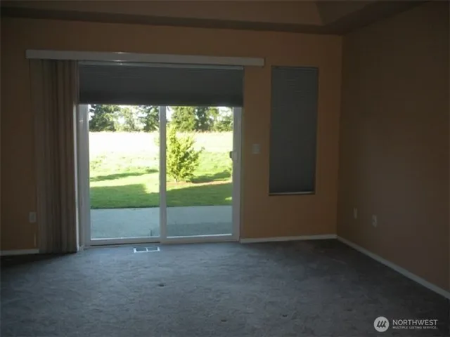 a view of empty room with floor to ceiling window
