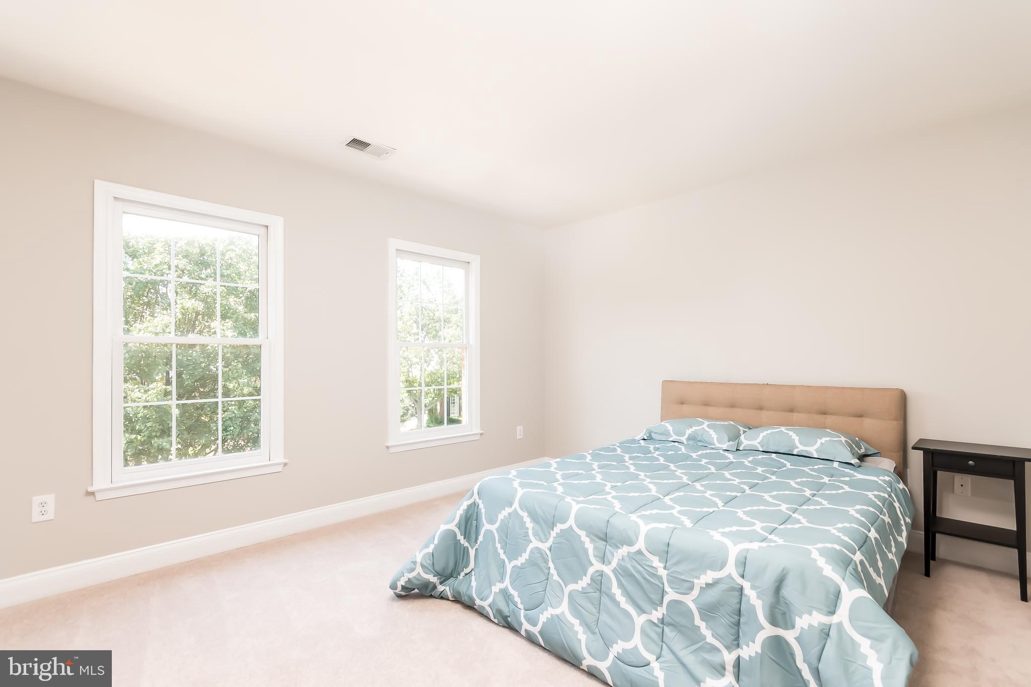 43268 Hillhead Place Leesburg, VA 20176 - Photo 26 of 53 a large bed sitting in a bedroom next to a window