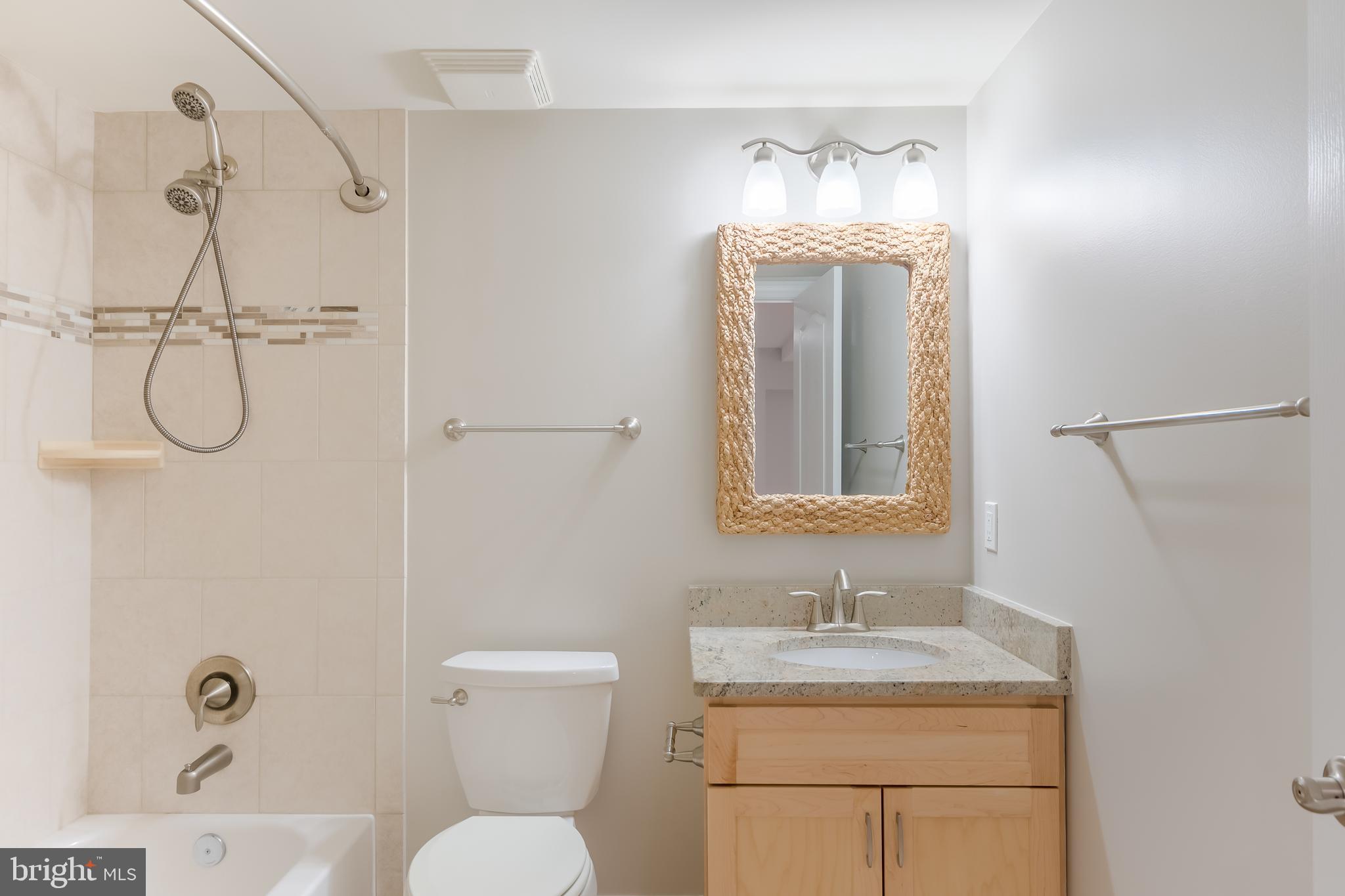 43268 Hillhead Place Leesburg, VA 20176 - Photo 35 of 53 a bathroom with a granite countertop sink a toilet and shower