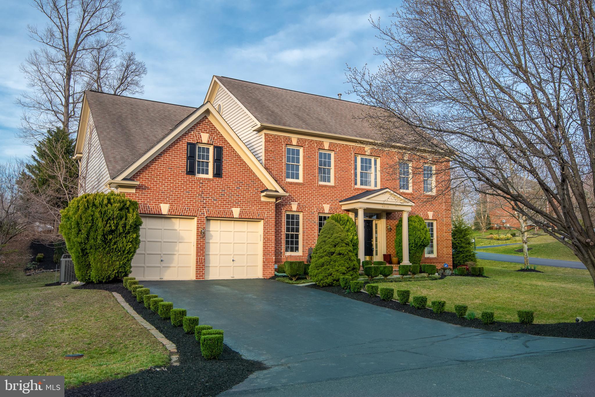 43268 Hillhead Place Leesburg, VA 20176 - Photo 47 of 53 a front view of a house with a garden and plants