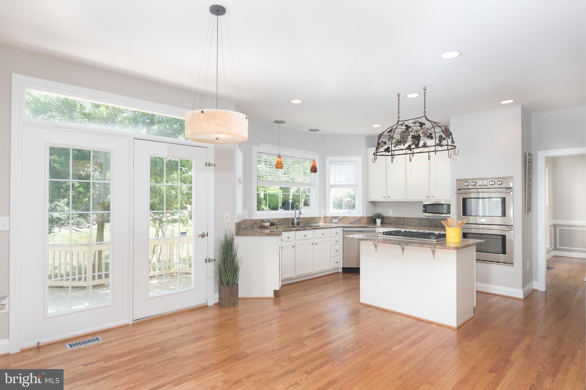 43268 Hillhead Place Leesburg, VA 20176 - Photo 5 of 53 a kitchen with stove and wooden floor