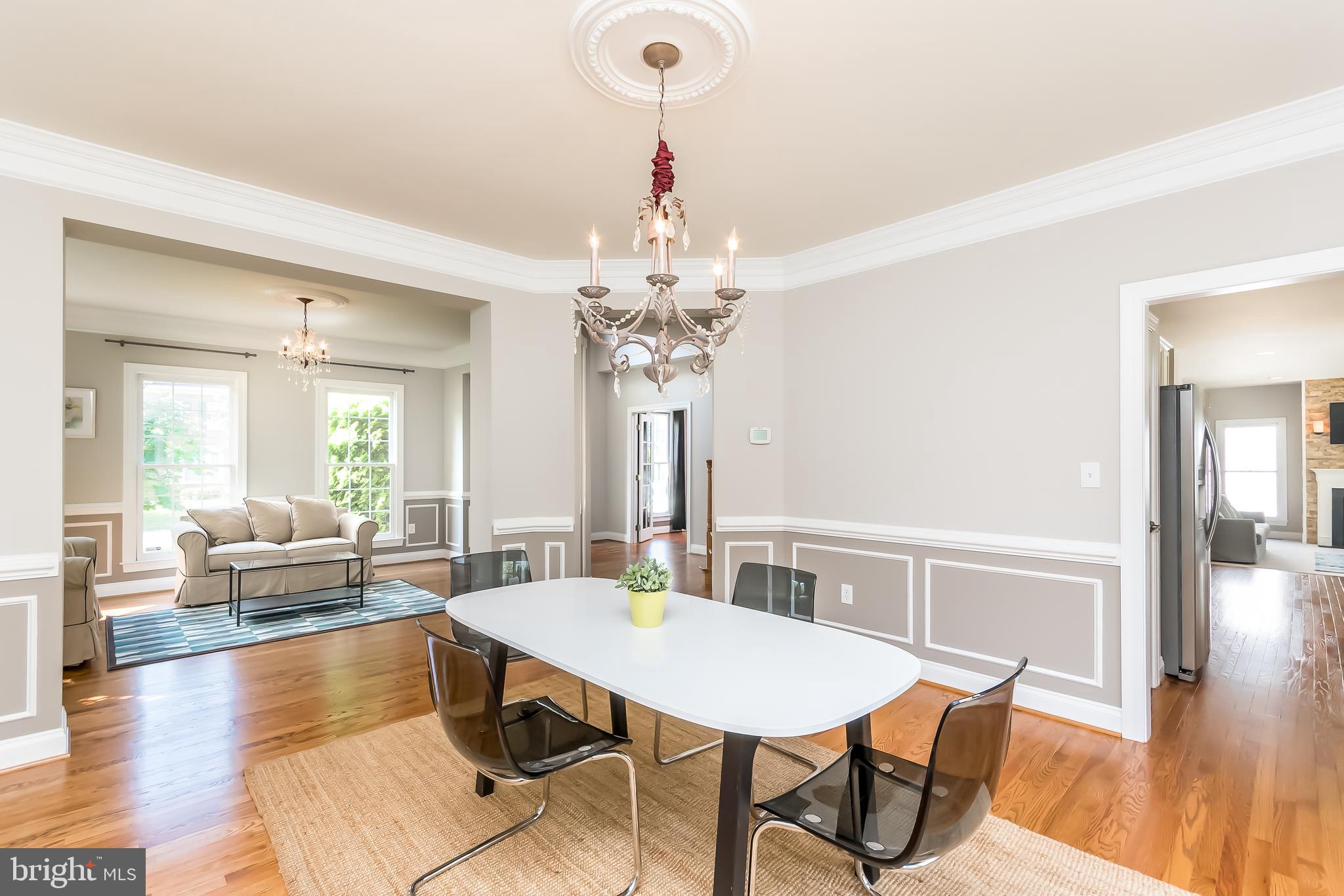 43268 Hillhead Place Leesburg, VA 20176 - Photo 10 of 53 a view of a dining room with furniture wooden floor and chandelier