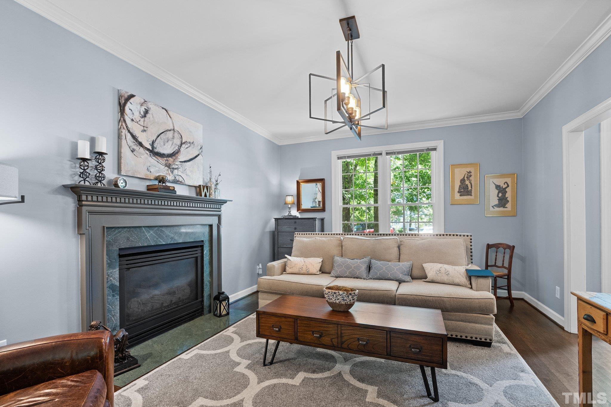 9 Montcrest Drive Durham, NC 27713 - Photo 11 of 43 a living room with furniture a chandelier and a fireplace