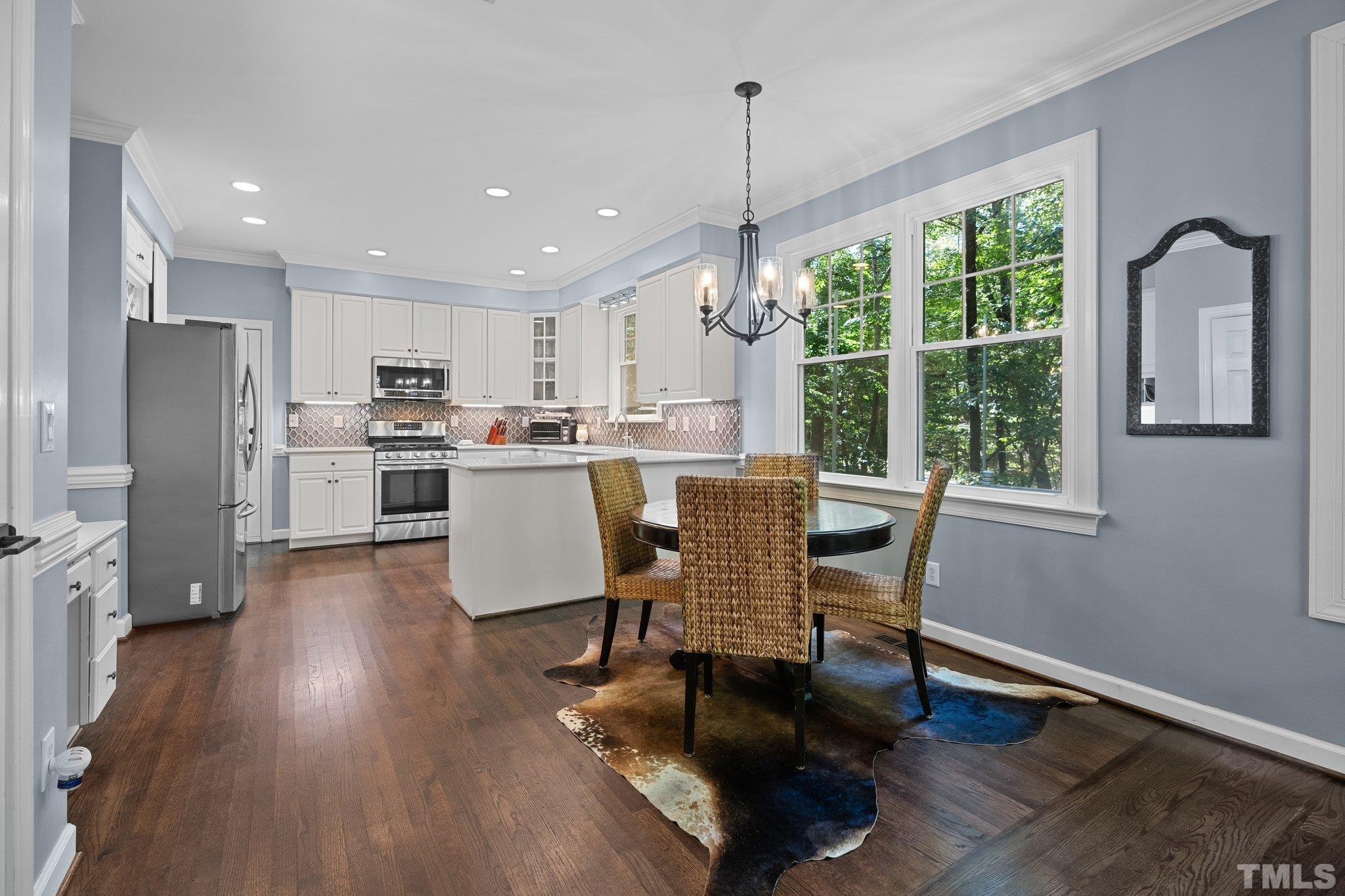 9 Montcrest Drive Durham, NC 27713 - Photo 16 of 43 a dining room with stainless steel appliances granite countertop furniture a refrigerator a kitchen island a stove a refrigerator with a dining table and chairs