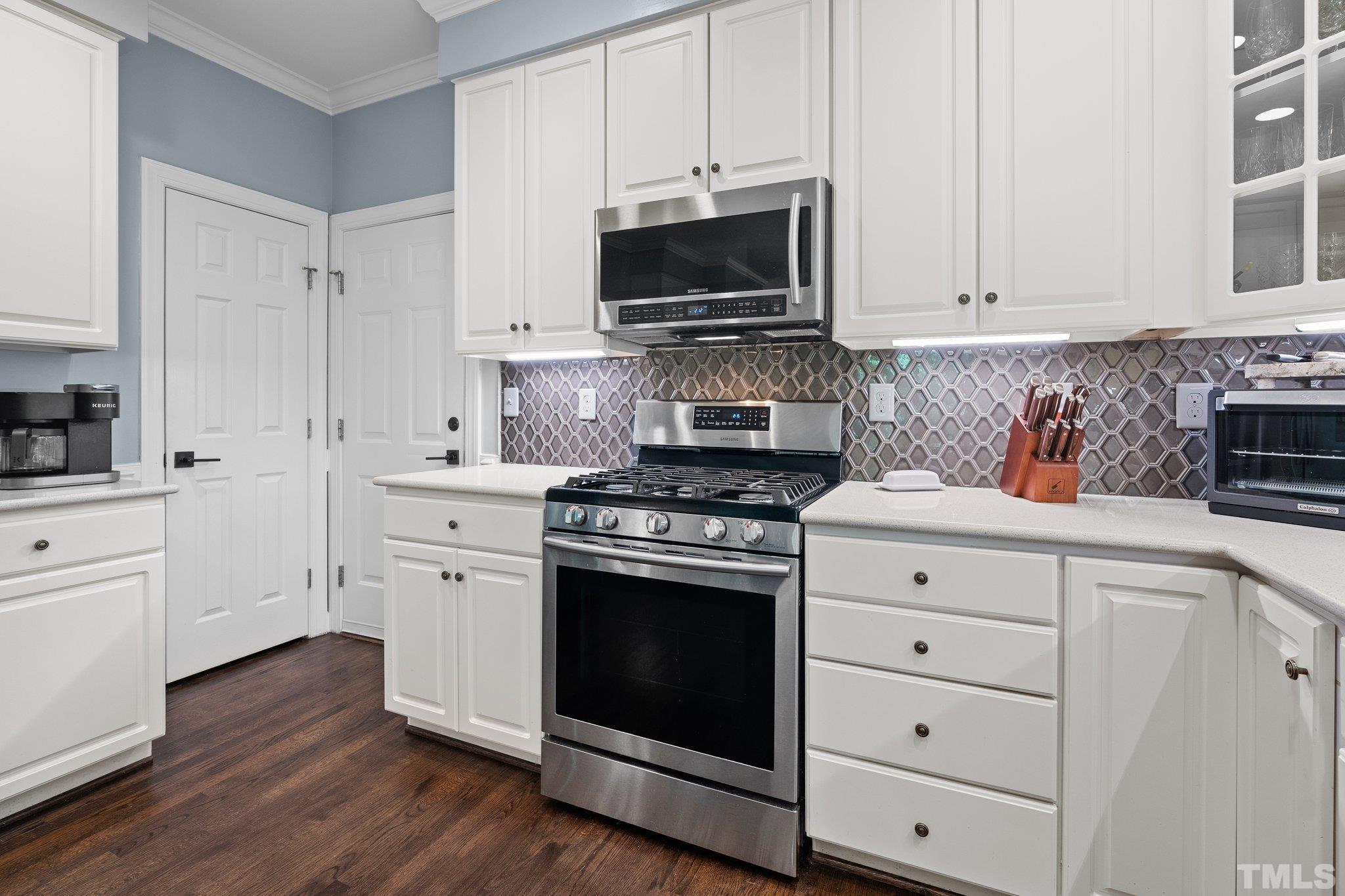 9 Montcrest Drive Durham, NC 27713 - Photo 23 of 43 a kitchen with white cabinets and stainless steel appliances