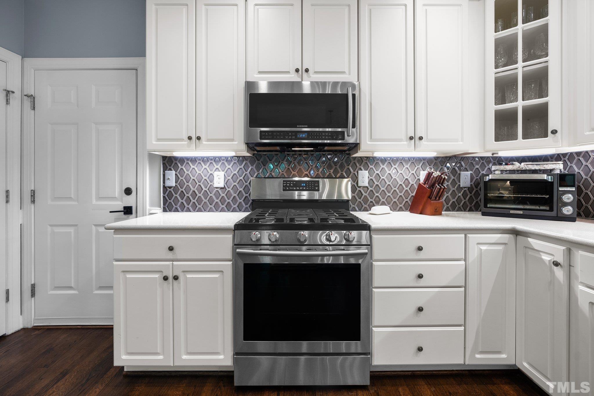 9 Montcrest Drive Durham, NC 27713 - Photo 24 of 43 a kitchen with stainless steel appliances a stove a microwave and sink