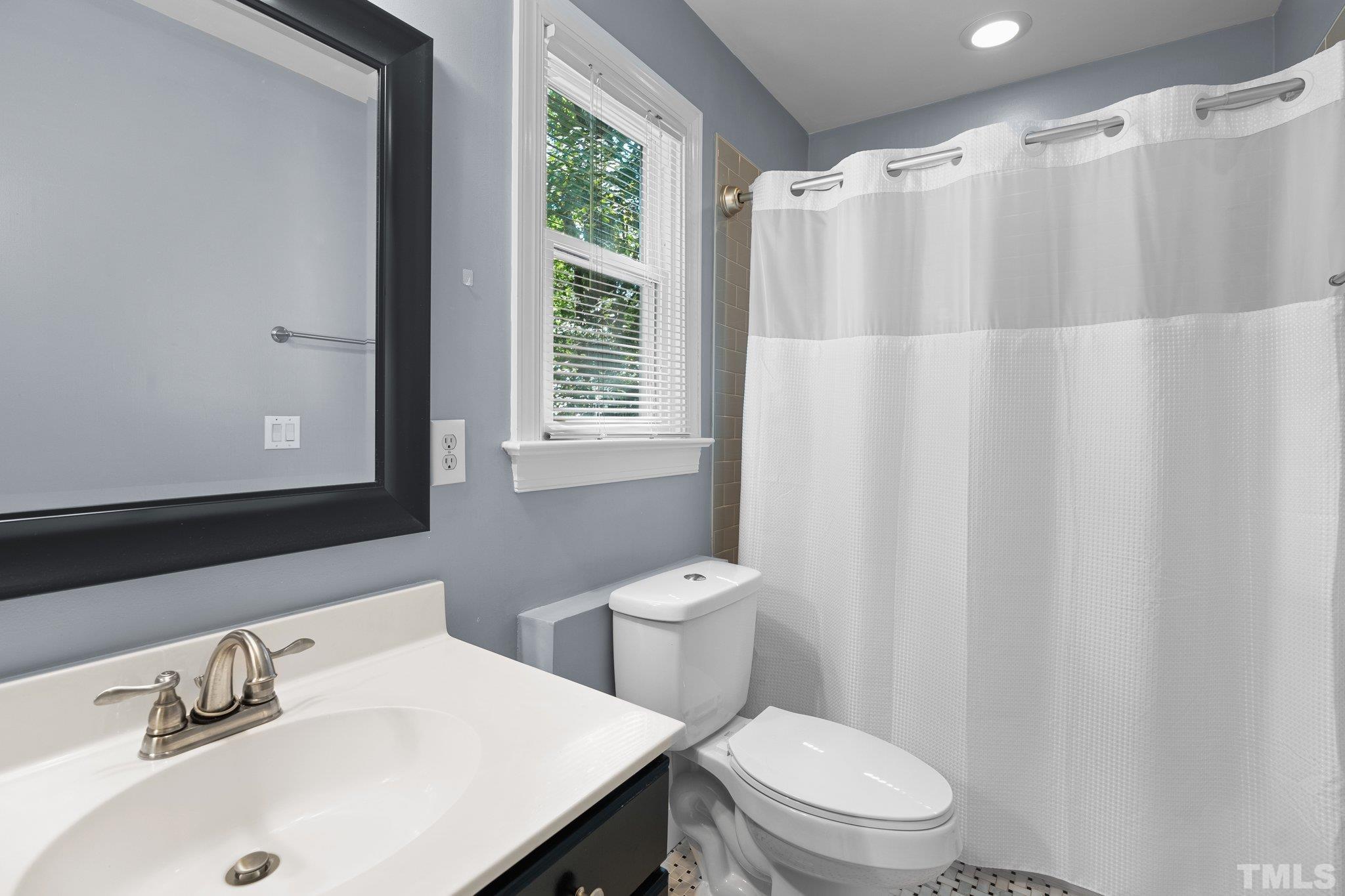 9 Montcrest Drive Durham, NC 27713 - Photo 35 of 43 a bathroom with a sink a toilet and shower curtain