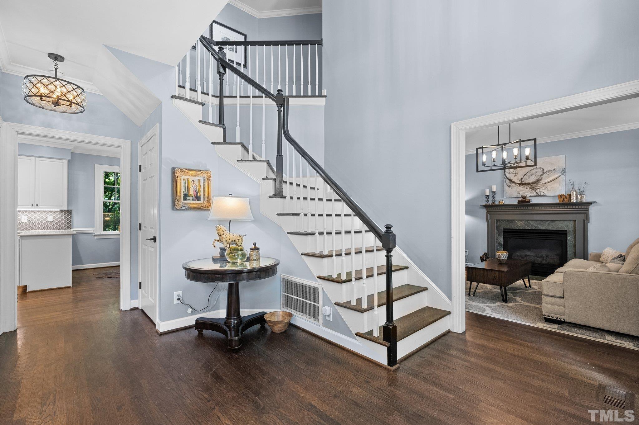 9 Montcrest Drive Durham, NC 27713 - Photo 4 of 43 a view of a livingroom with furniture stairs a fireplace and windows