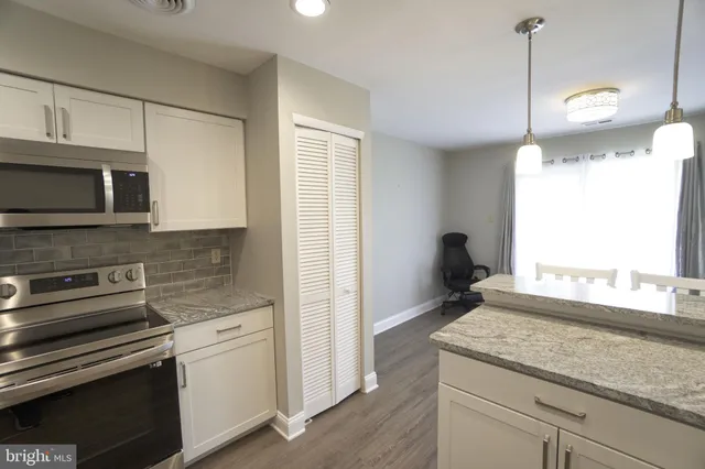 a kitchen with a sink and a microwave