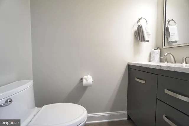 a bathroom with a sink a toilet and vanity