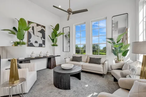 a living room with kitchen island furniture and a potted plant