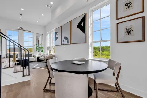 a living room with furniture and a painting on the wall