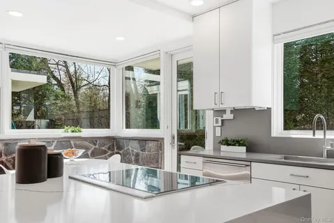 a kitchen with granite countertop a large window and a sink