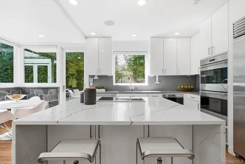 a kitchen with a sink a counter top space cabinets and stainless steel appliances