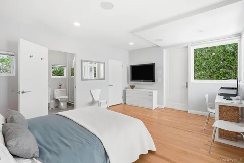 a bedroom with a bed and a flat screen tv