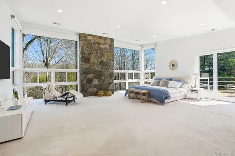 a bedroom with furniture and a large window