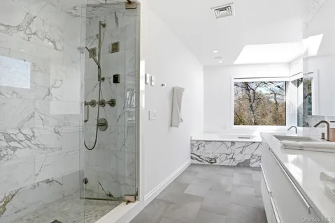 a bathroom with a granite countertop sink a toilet and shower