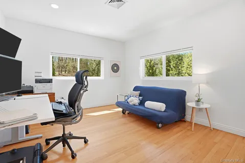 a view of a livingroom with workspace and a window