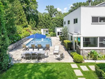 a view of a house with a yard and sitting area