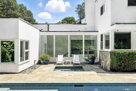 a view of a house with backyard and sitting area