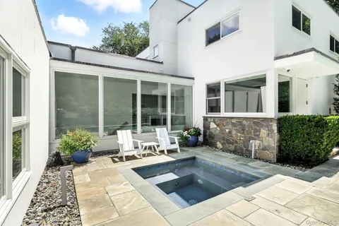 a house with potted plants in front of it