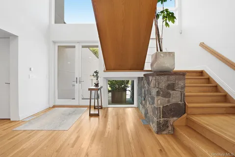 a view of a hallway with wooden floor and staircase