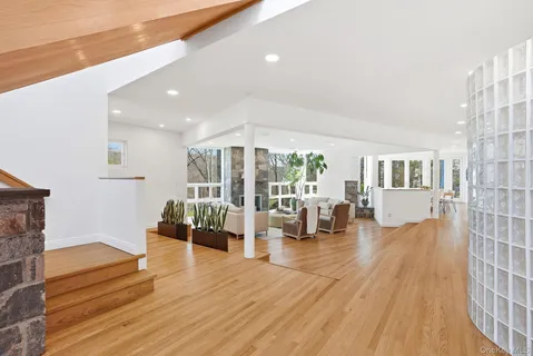 a living room with furniture and large wooden floor