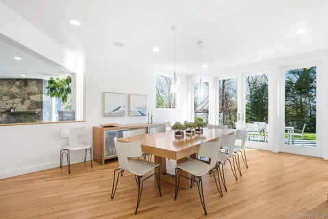 a view of a dining room with furniture large windows and wooden floor