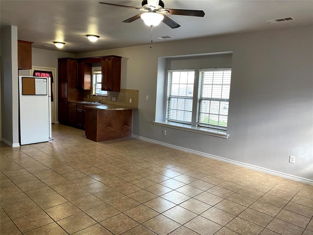 906 Parkplace Ridge Princeton, TX 75407 - Photo 19 of 31 Open-concept living area with tiled flooring and a ceiling fan