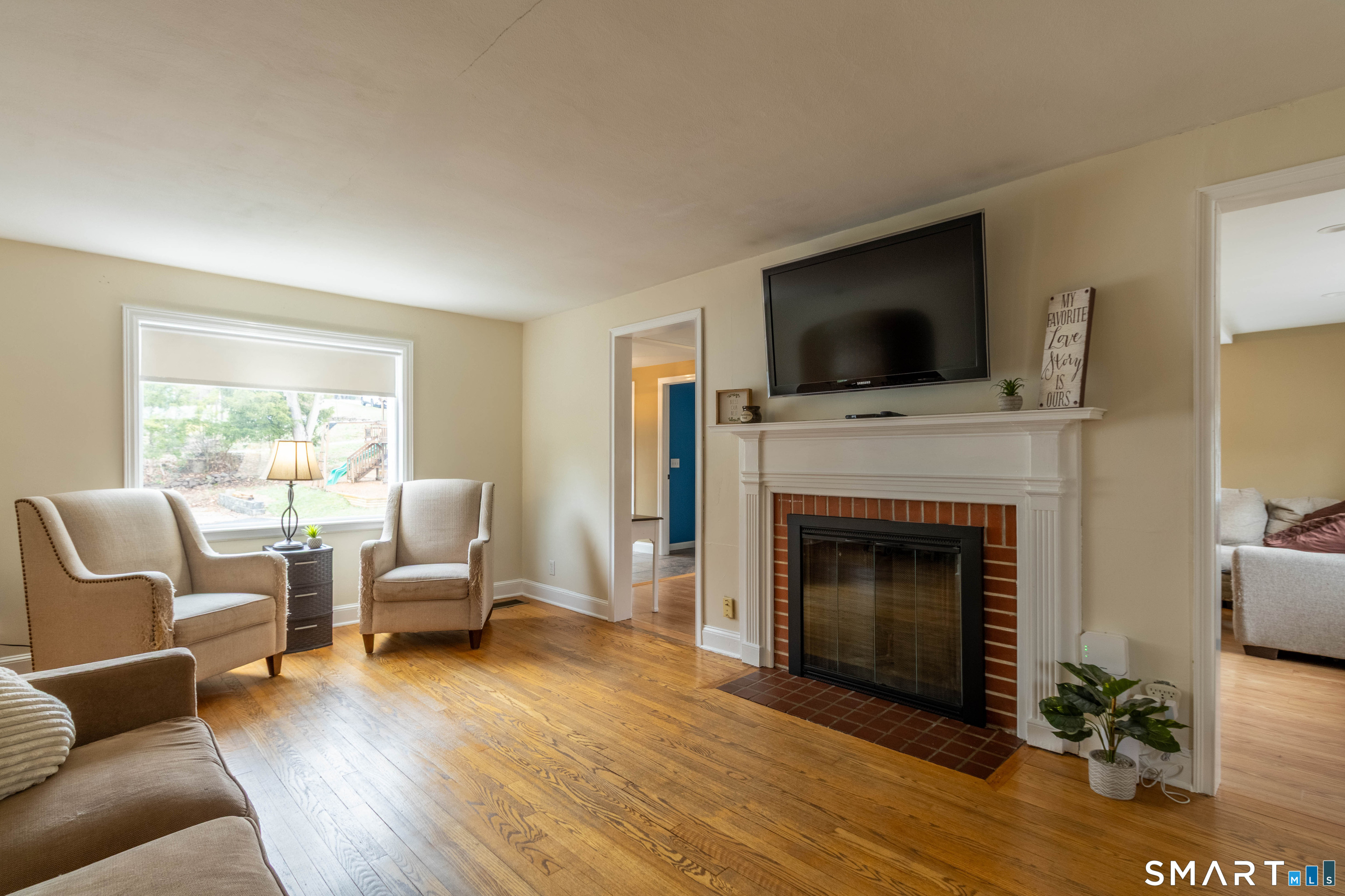 535 Lower Lane Berlin, CT 06037 - Photo 11 of 40 a living room with furniture flat screen tv and a fireplace