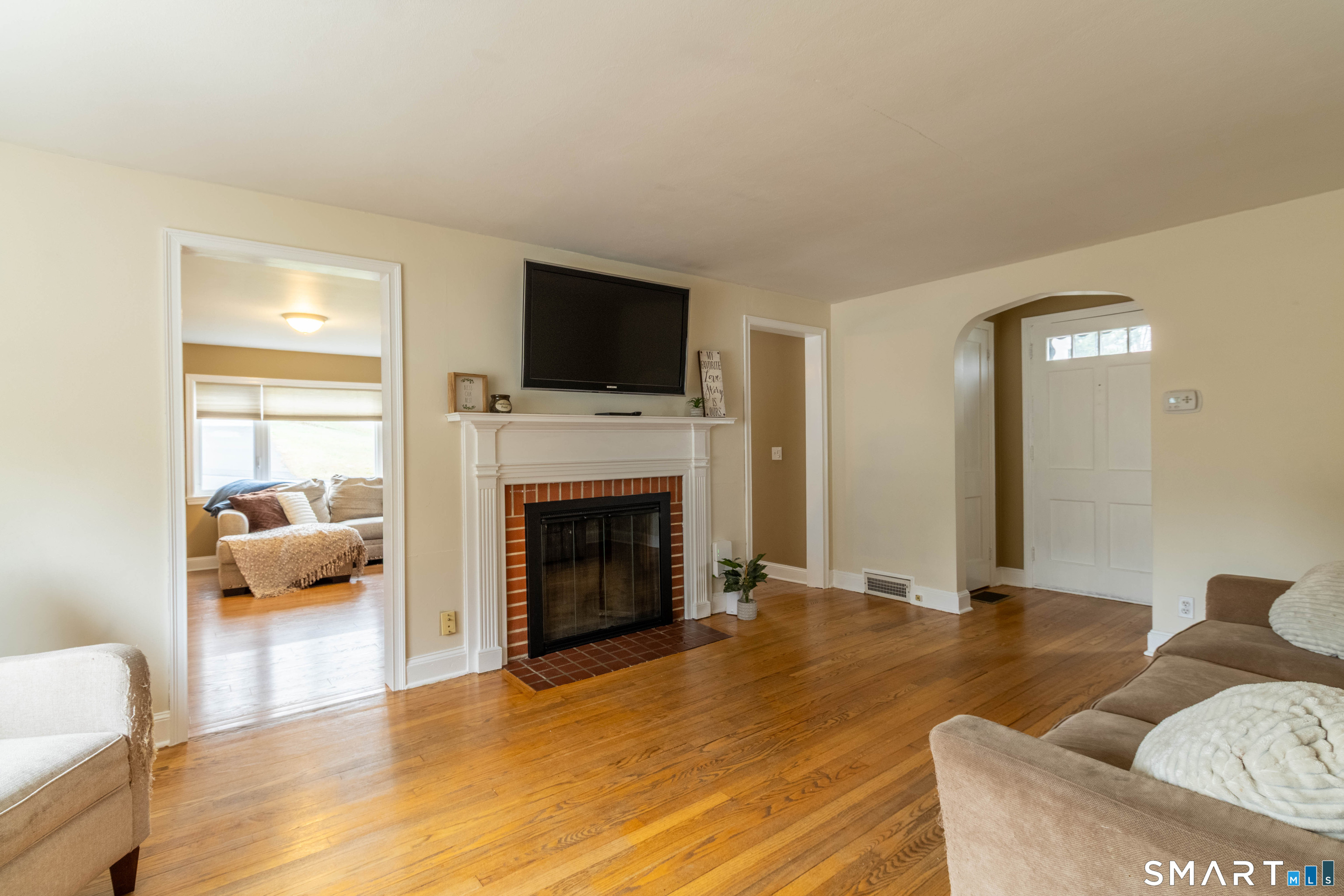 535 Lower Lane Berlin, CT 06037 - Photo 12 of 40 a living room with furniture a fireplace and a flat screen tv