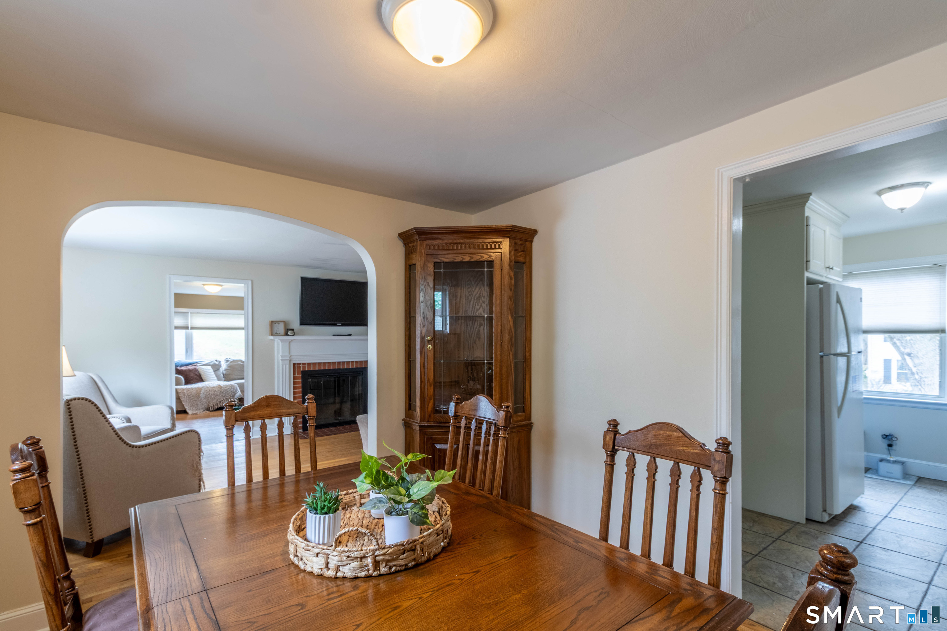 535 Lower Lane Berlin, CT 06037 - Photo 16 of 40 a view of a dining room with furniture a fireplace and wooden floor