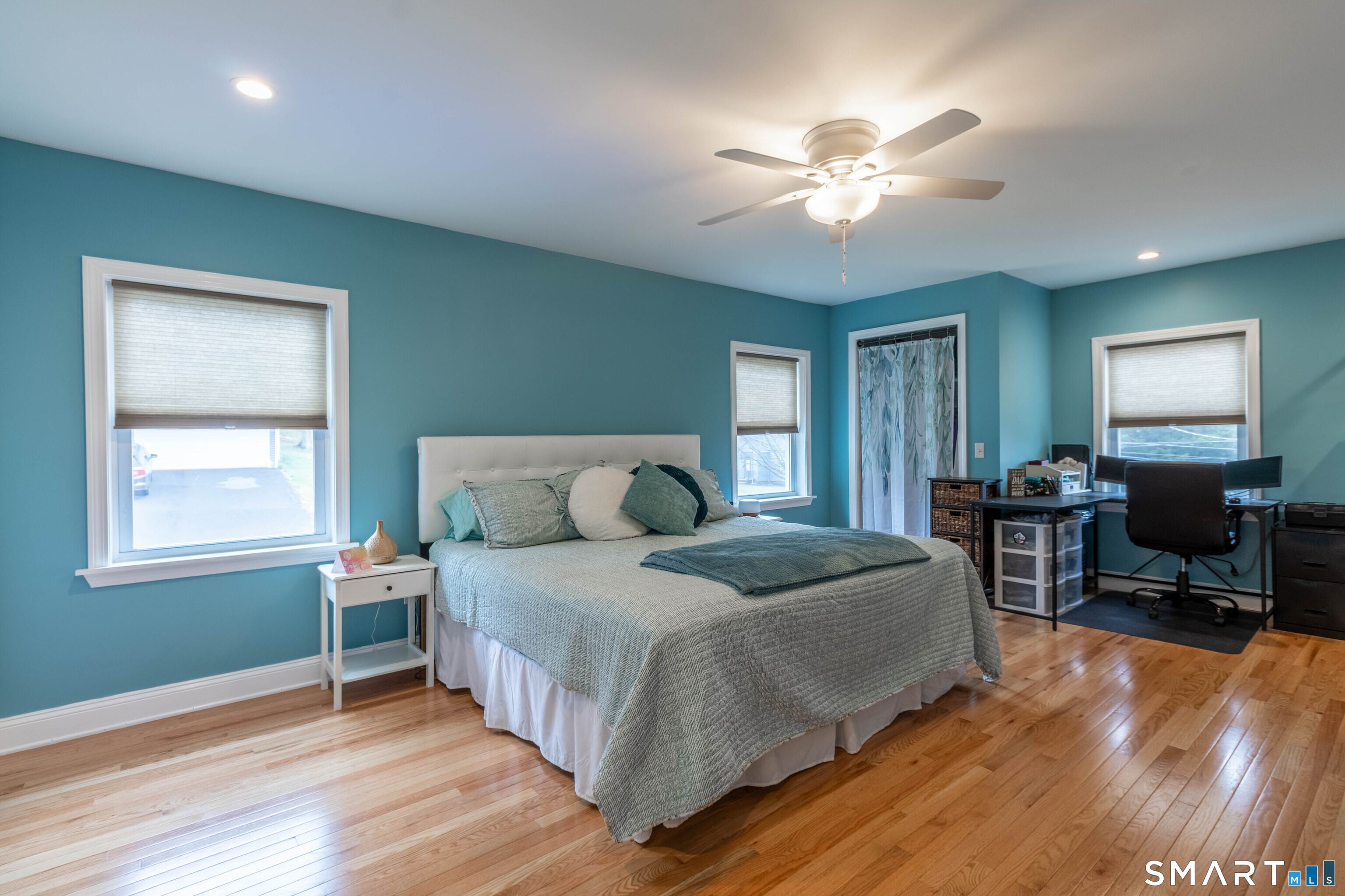 535 Lower Lane Berlin, CT 06037 - Photo 29 of 40 a spacious bedroom with a bed and a chandelier