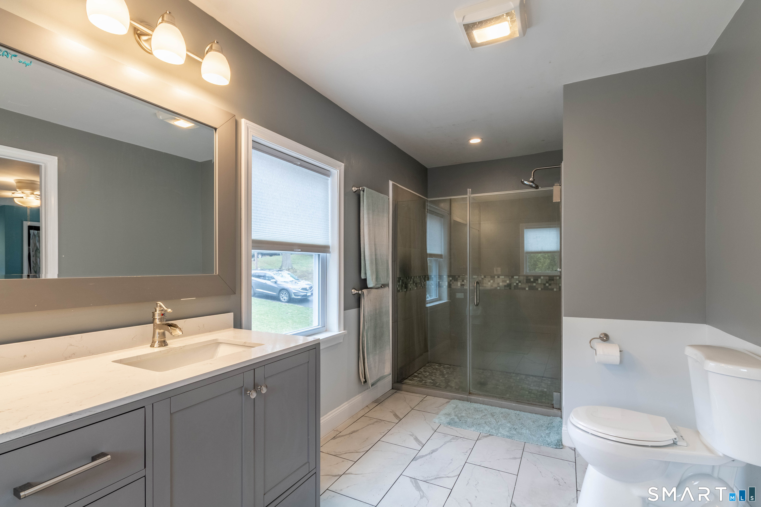 535 Lower Lane Berlin, CT 06037 - Photo 32 of 40 a bathroom with a double vanity sink toilet and shower