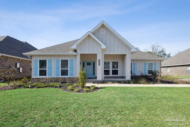 a front view of house with a garden and patio