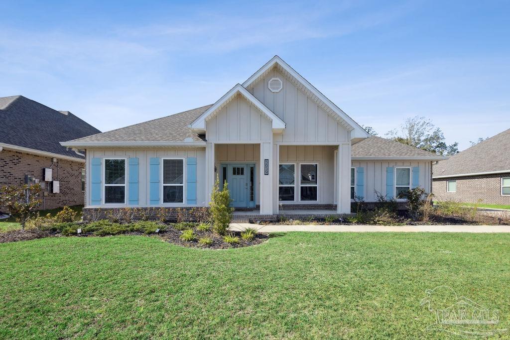 a front view of house with a garden and patio