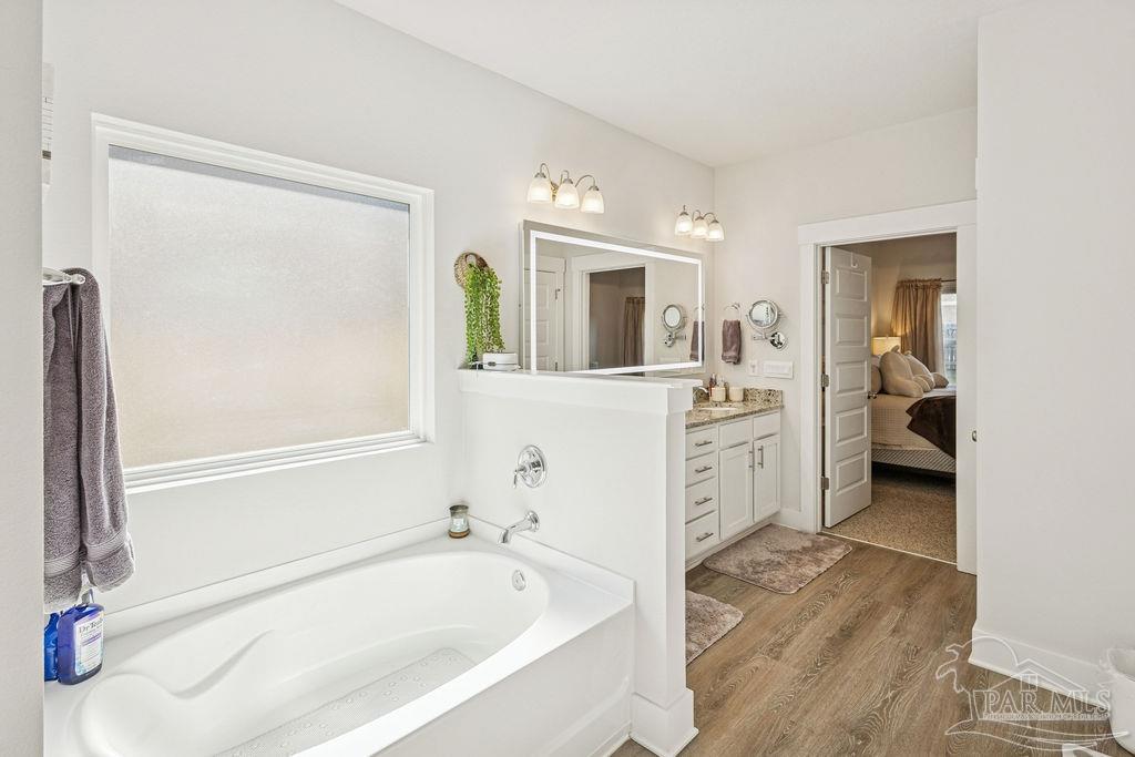 5659 Blake Lane Pace, FL 32571 - Photo 11 of 38 a spacious bathroom with a tub sink and mirror