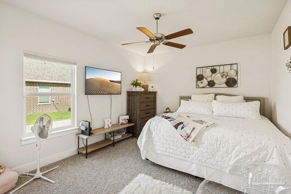 5659 Blake Lane Pace, FL 32571 - Photo 15 of 38 a bed room with a bed and a window