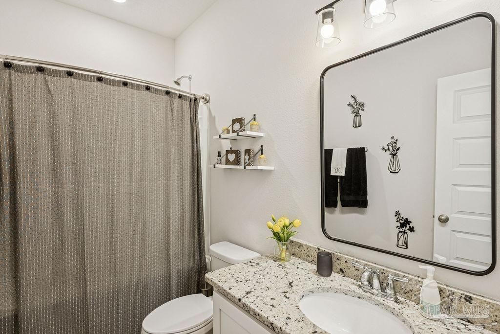 5659 Blake Lane Pace, FL 32571 - Photo 17 of 38 a bathroom with a granite countertop sink toilet and shower