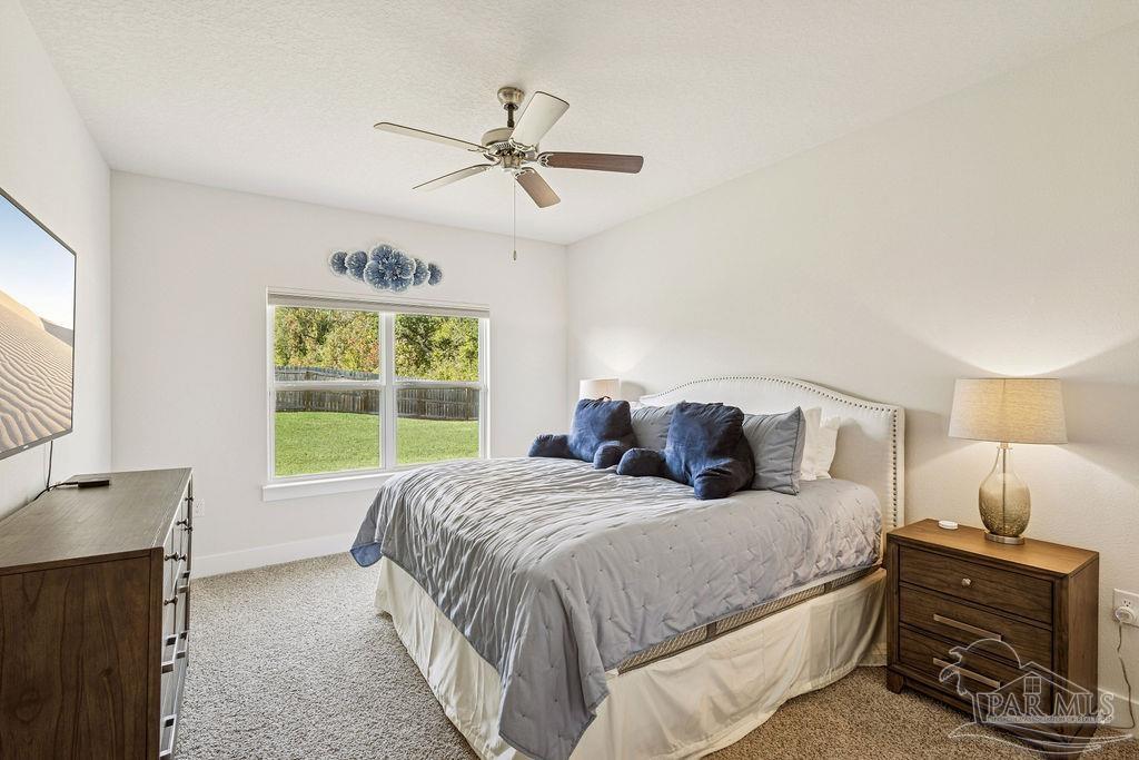 5659 Blake Lane Pace, FL 32571 - Photo 19 of 38 a bedroom with a bed and a window