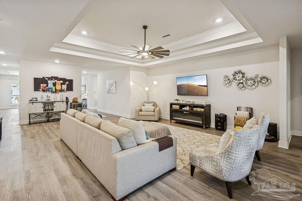 5659 Blake Lane Pace, FL 32571 - Photo 2 of 38 a living room with furniture and a flat screen tv
