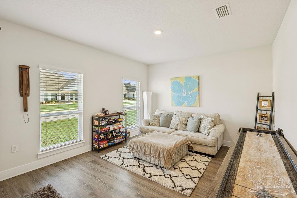 5659 Blake Lane Pace, FL 32571 - Photo 21 of 38 a living room with furniture and a wooden floor
