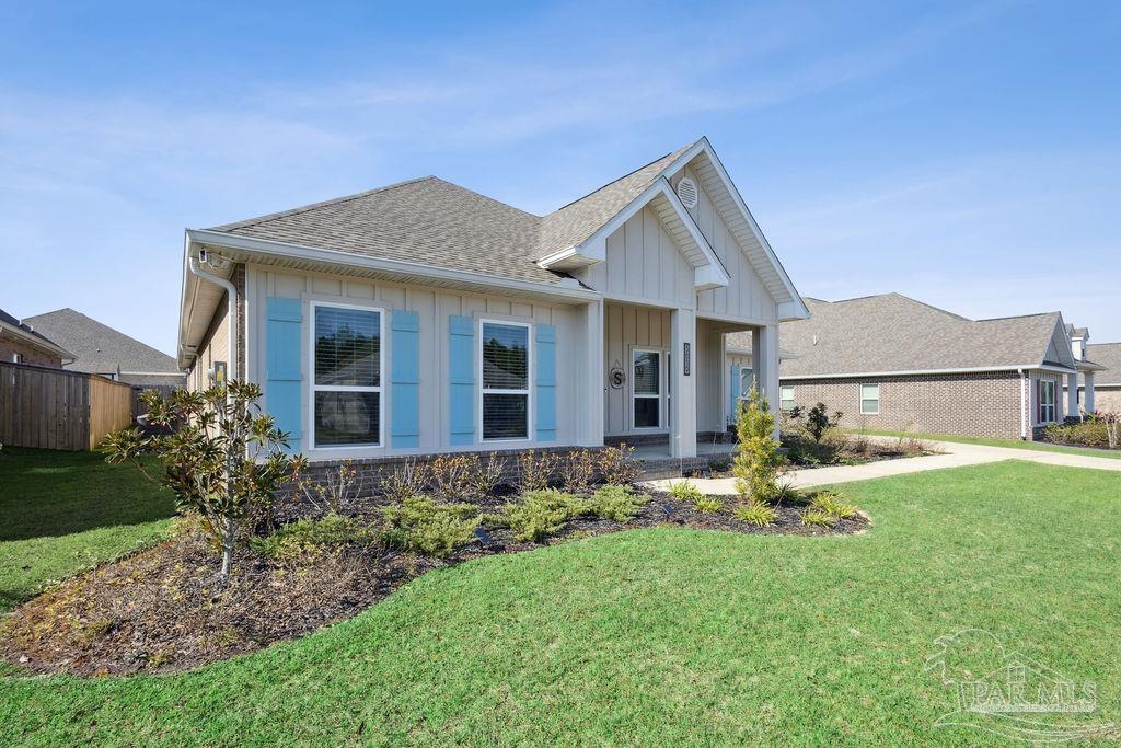 5659 Blake Lane Pace, FL 32571 - Photo 31 of 38 a front view of a house with garden