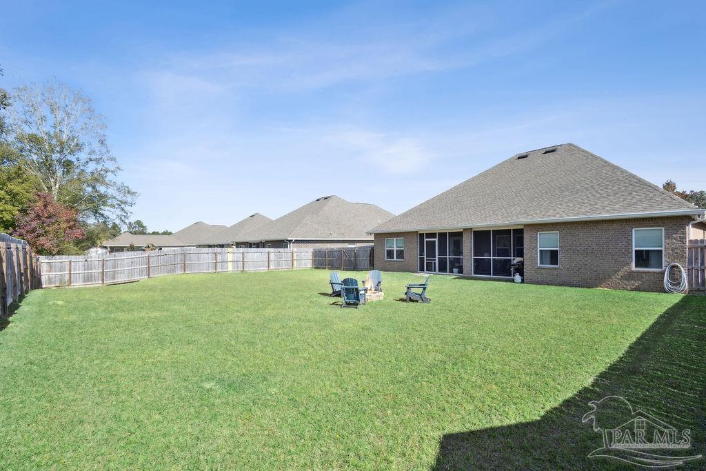 5659 Blake Lane Pace, FL 32571 - Photo 32 of 38 a backyard of a house with table and chairs