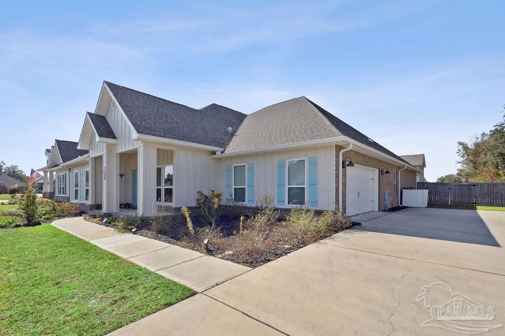 5659 Blake Lane Pace, FL 32571 - Photo 33 of 38 a front view of house with yard and green space