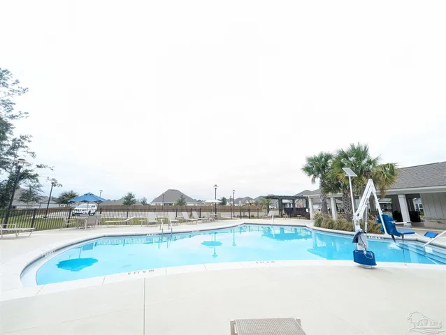 a view of a swimming pool and a chair